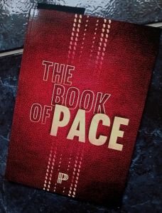 Book cover - title “The Book of Pace“ in white against a red leather effect background with the impression of the seam of a cricket ball printed vertically.
